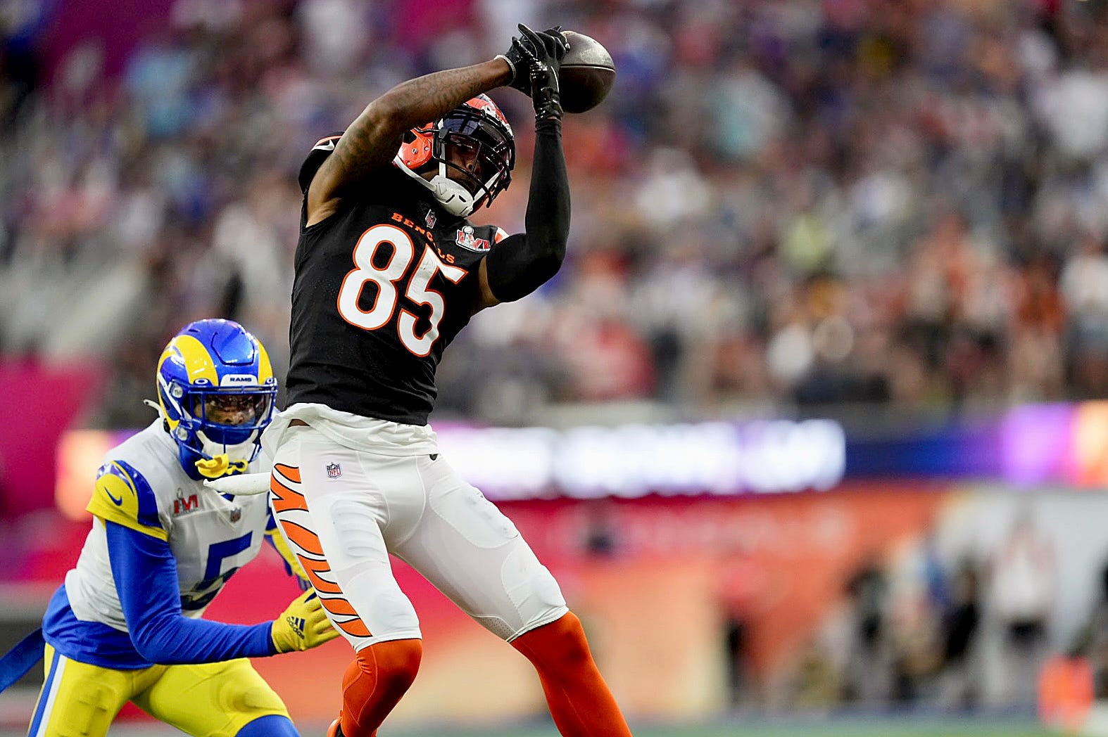 Football player catching pass midair