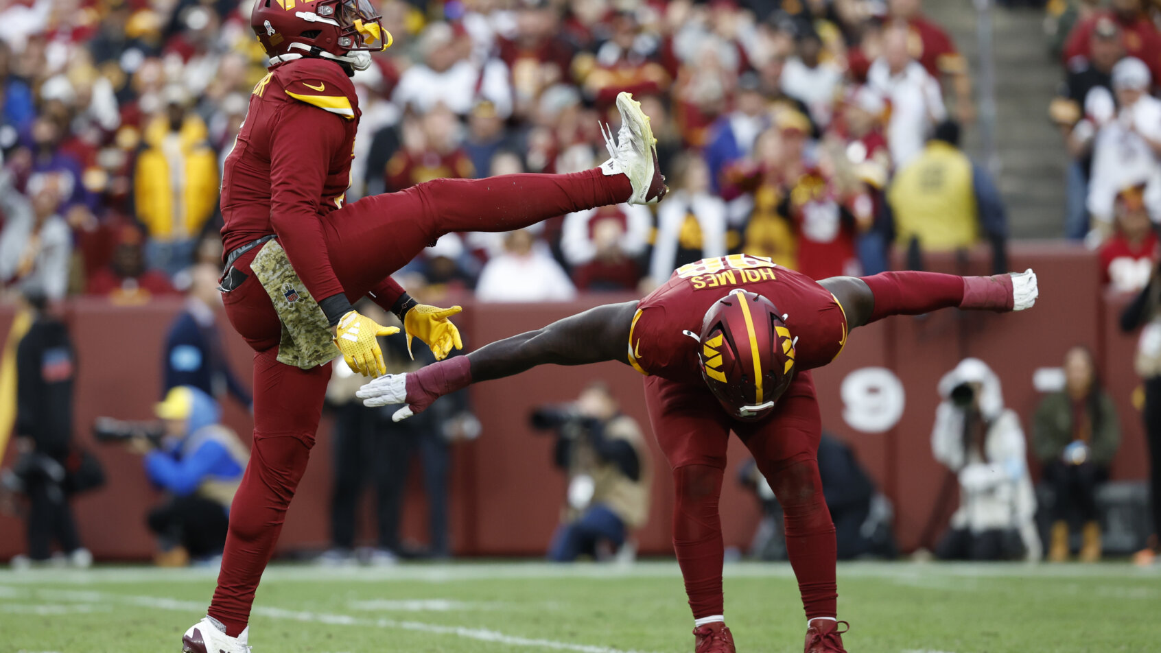 Football player performing a sliding tackle