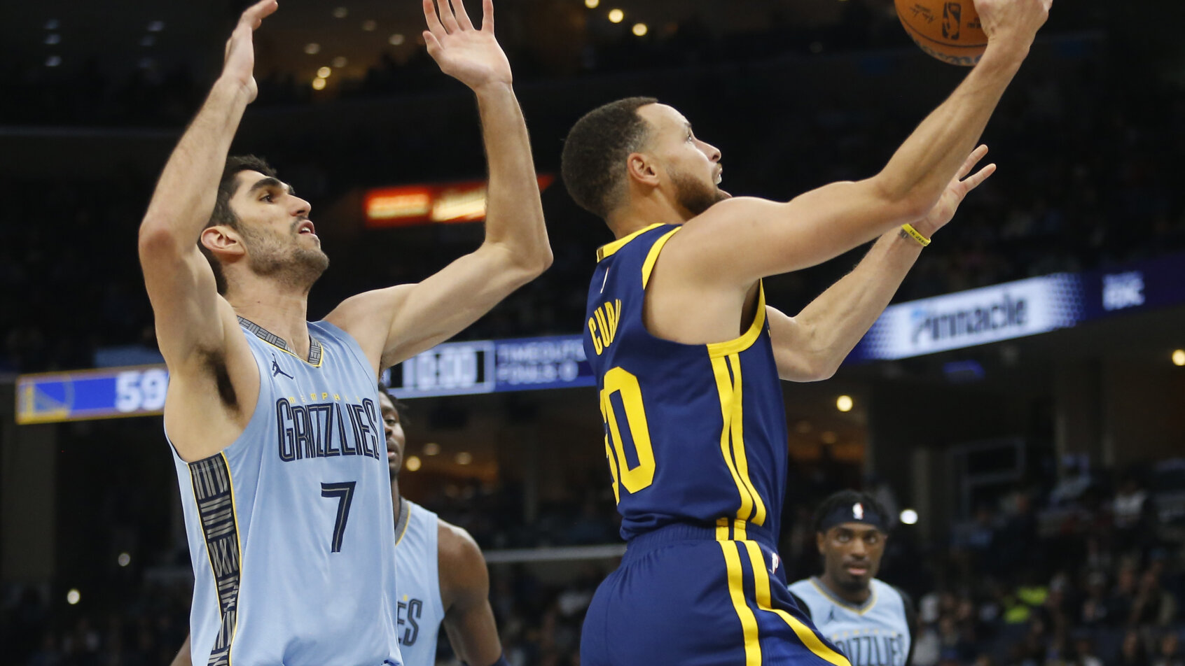 Basketball players jumping for rebound