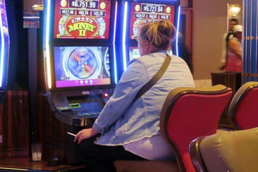 Woman playing slot machine