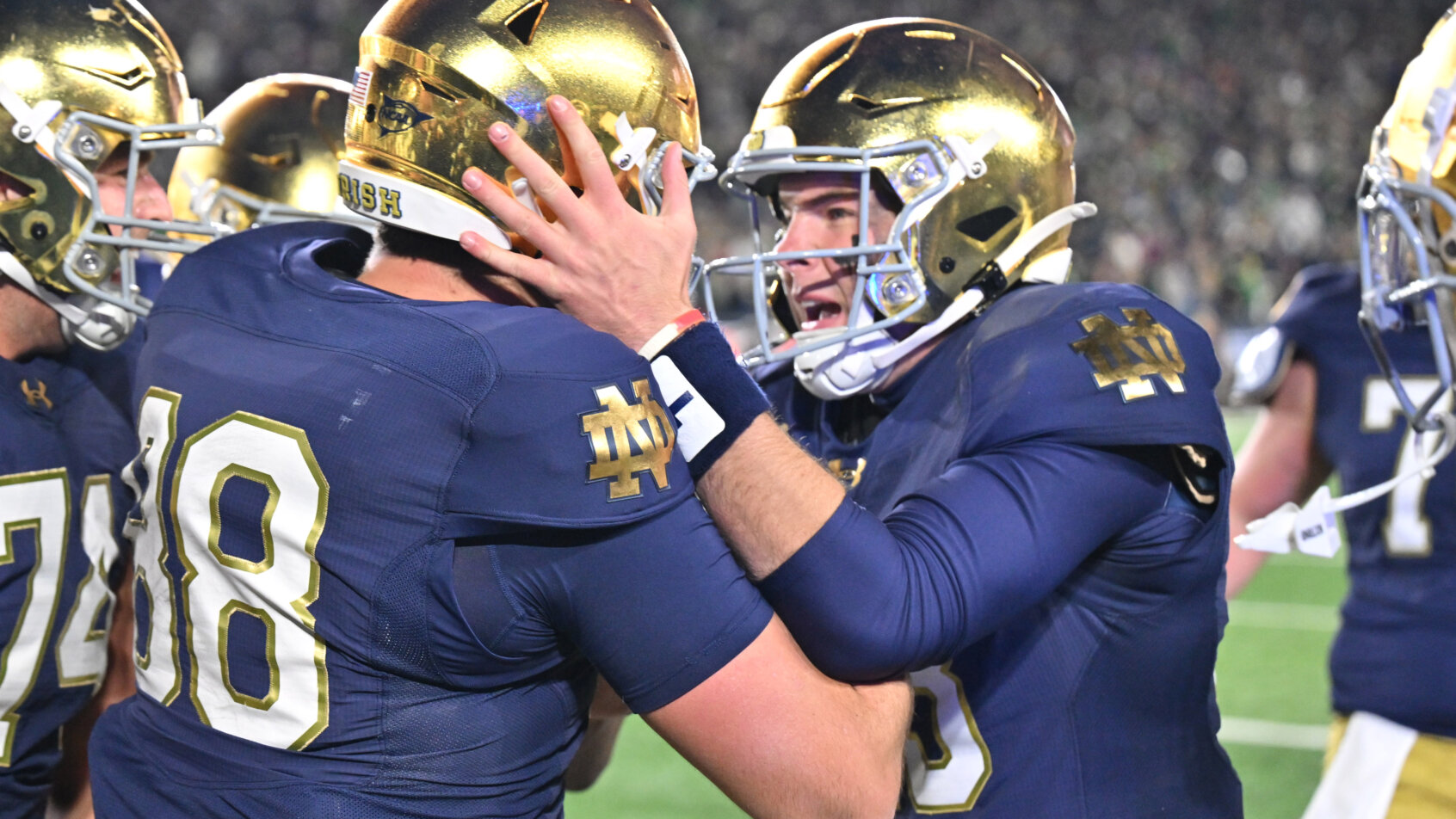 Two Navy football players tackle opponent