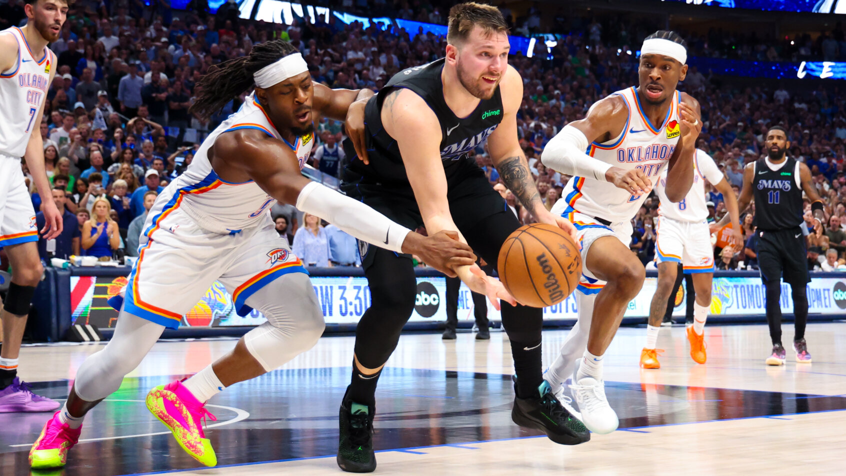 Two basketball players contest rebound