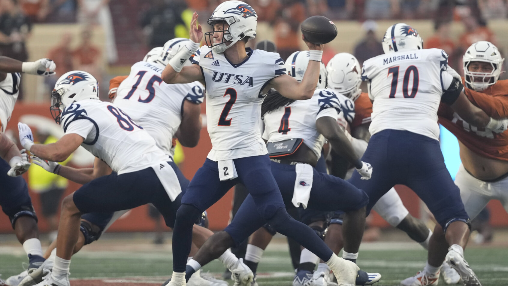 Football players collide in game action