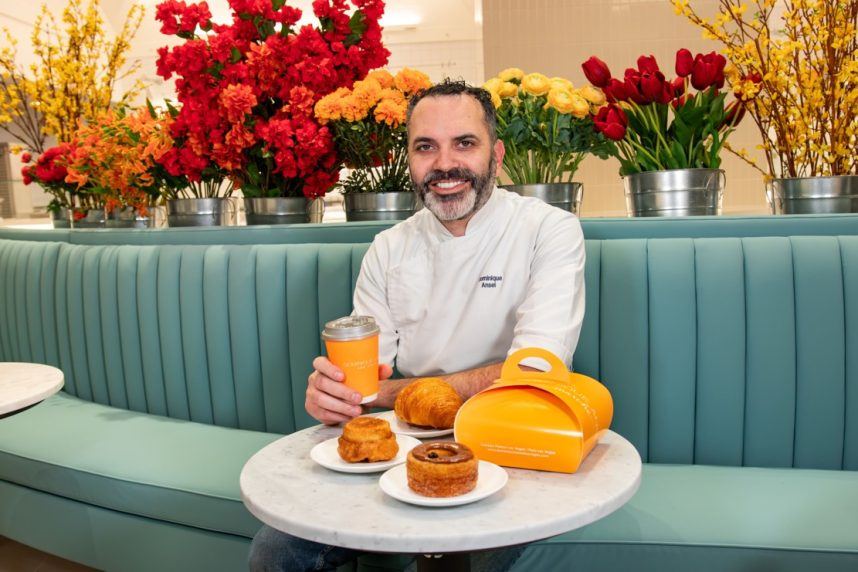 Man smiling with cronuts and beverage