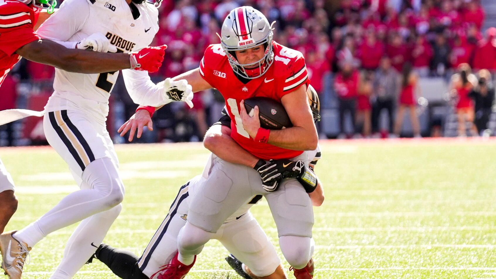 Running football player carries ball