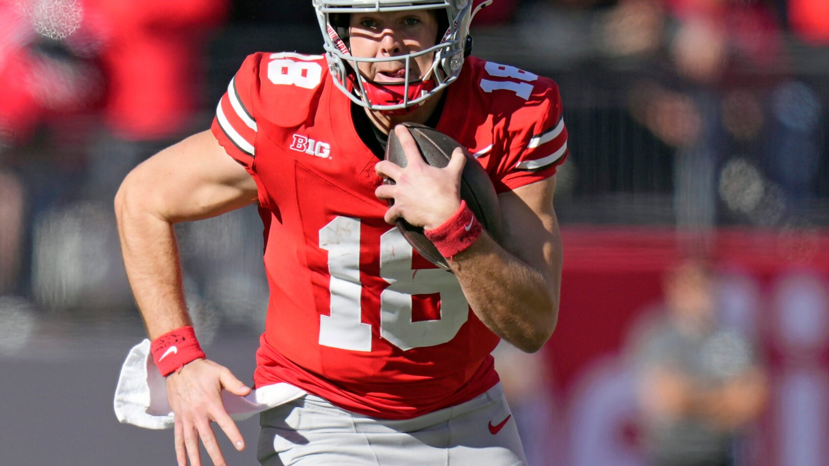 Football player carrying ball downfield