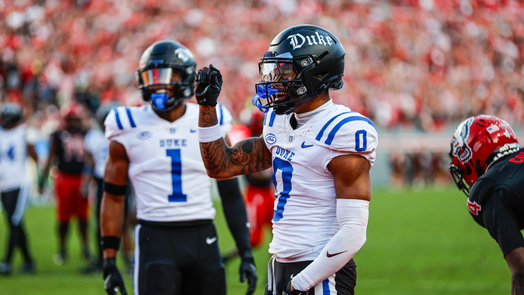 NFL player celebrates with raised arm