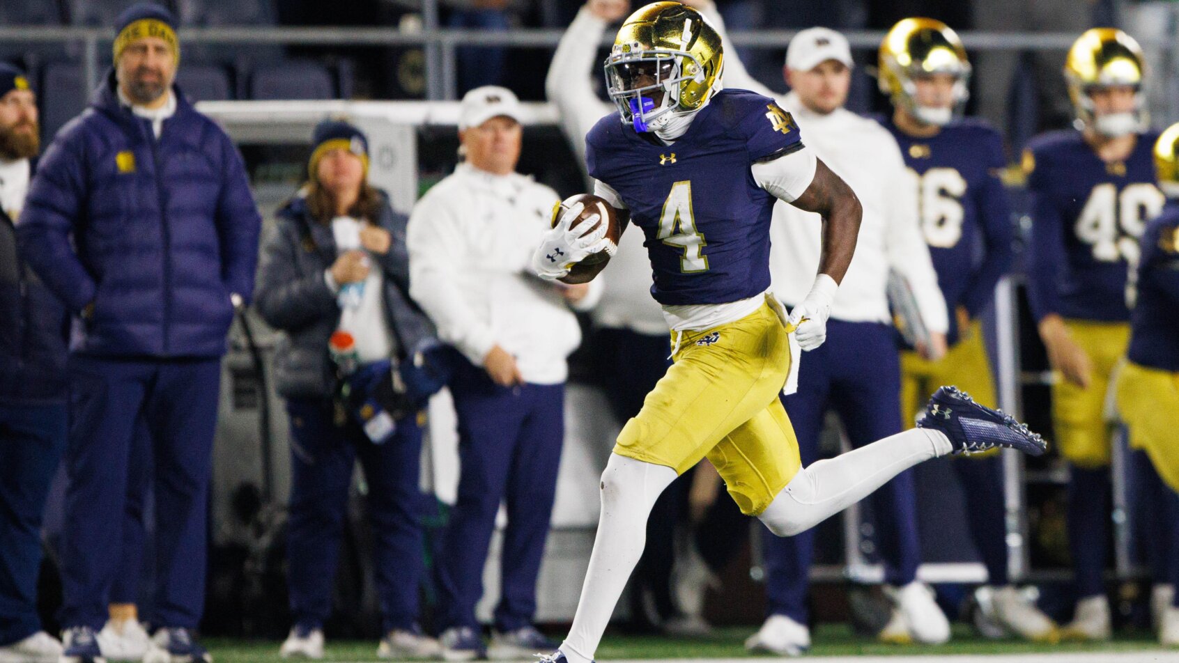 Player rushing with football ball