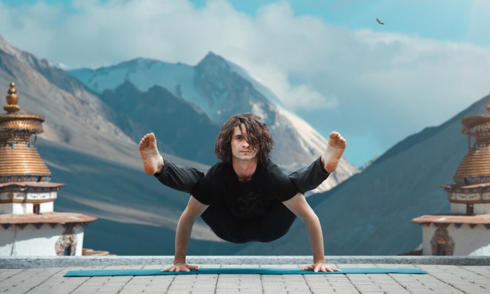 Man in yoga pose at sunrise