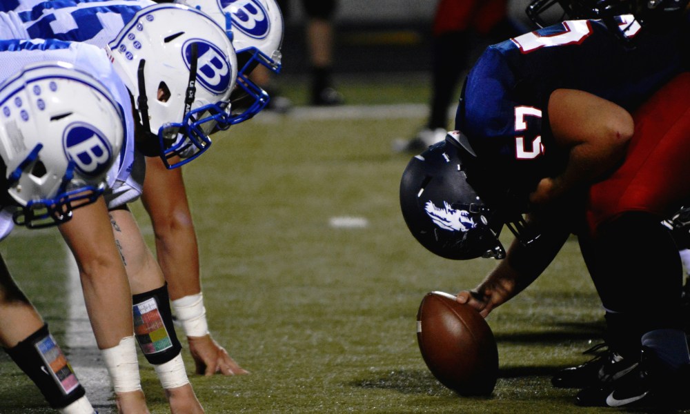 Football players in pre-snap position