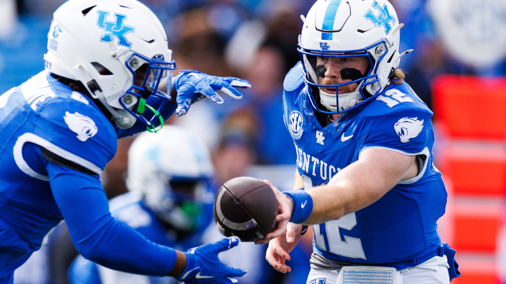 Football player hands off ball