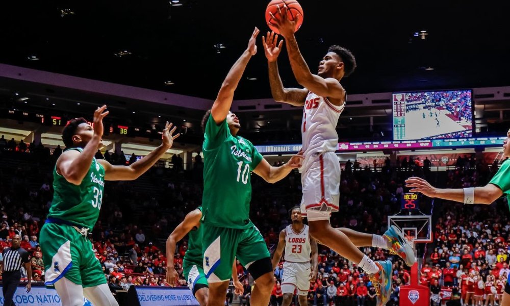 Basketball player dunks during game