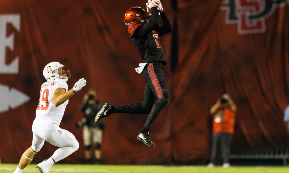 Football player catches ball mid-air