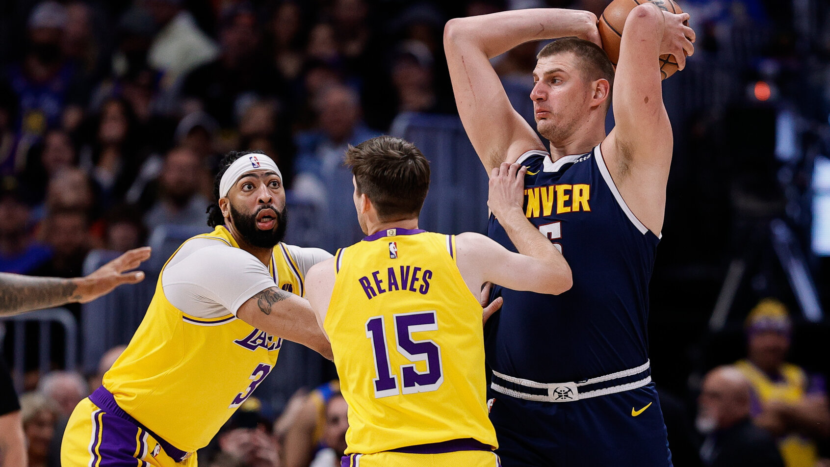 Basketball players compete during game