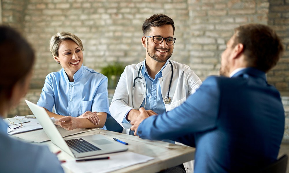 Doctor and businessman handshake