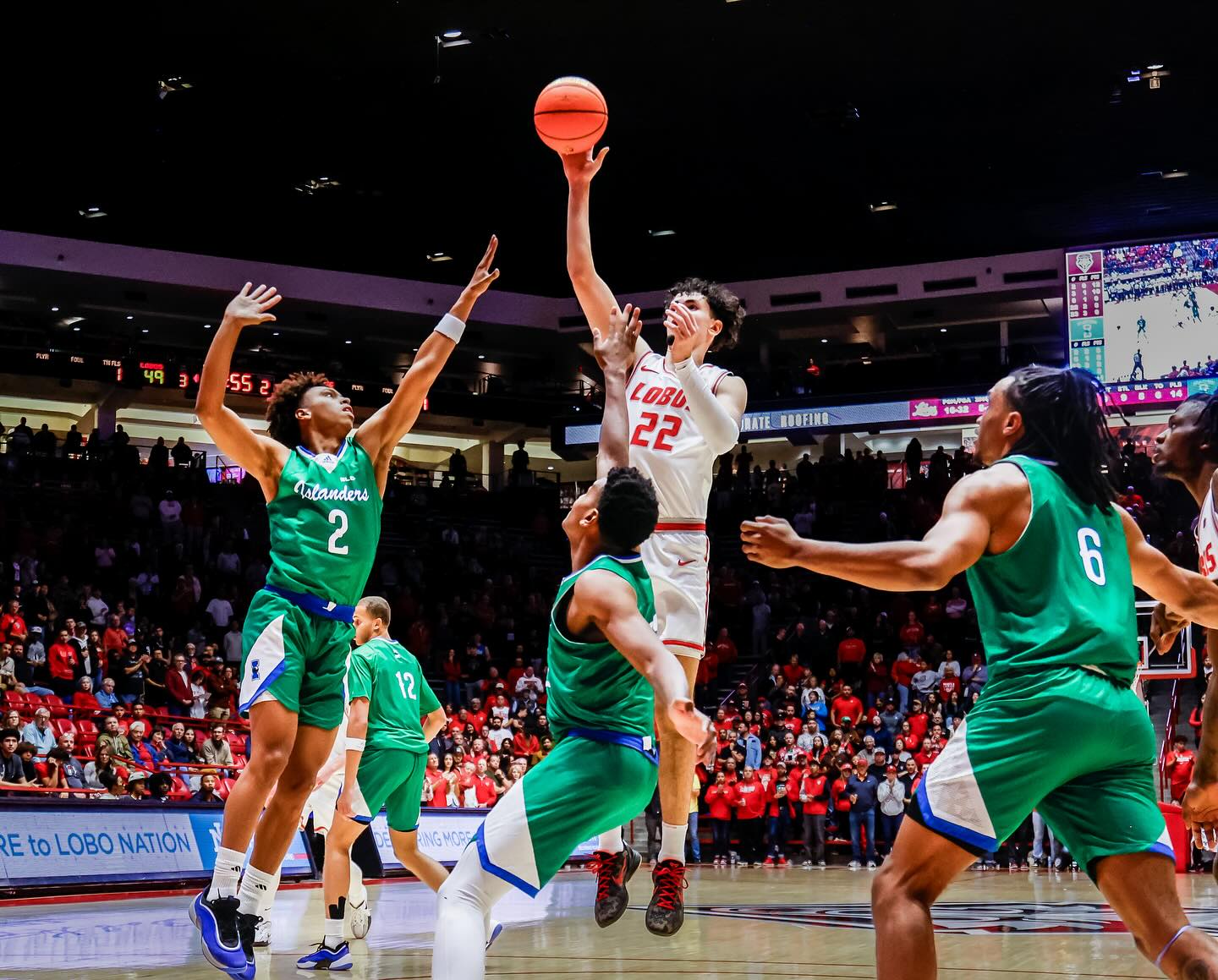 Basketball player shoots at basket