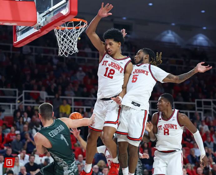 Basketball player dunking over defender