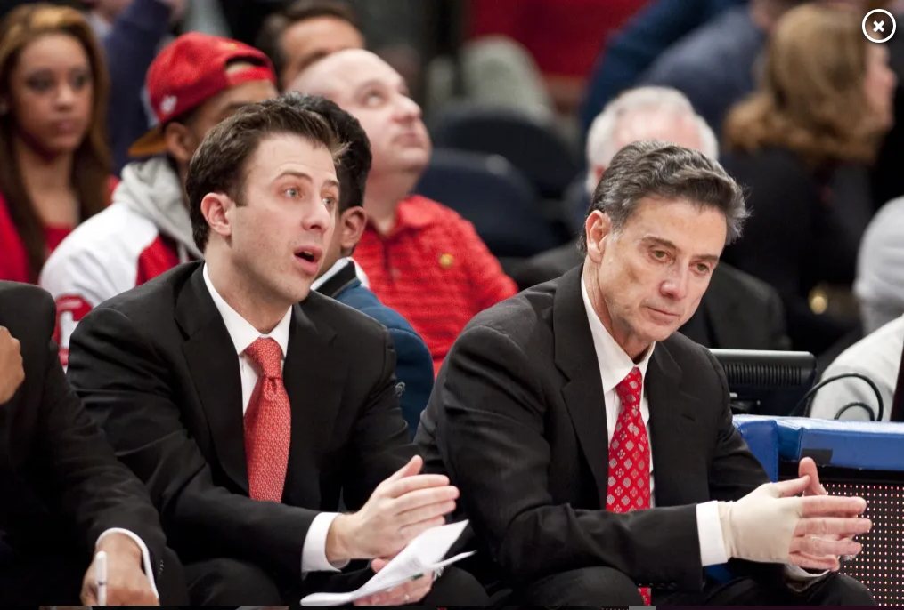 Two suited men on basketball court