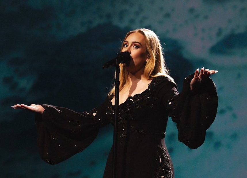 Adele wearing black dress on stage