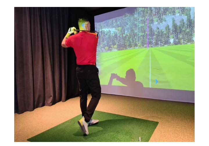 Golfer in indoor simulator