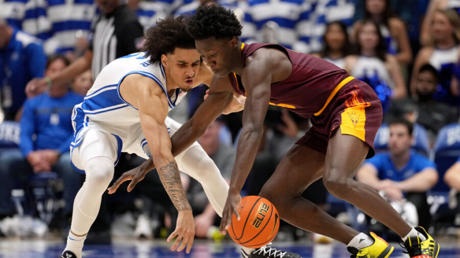 Basketball players fight for possession