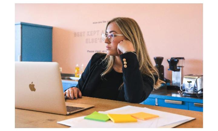 Woman working at laptop desk