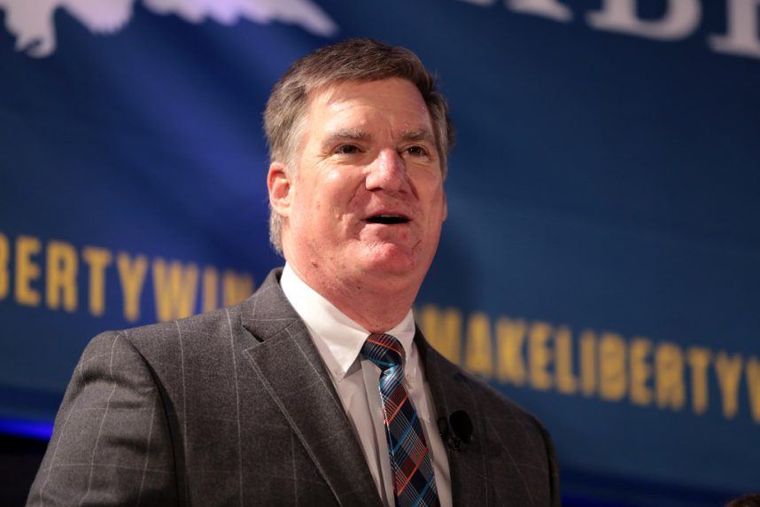 Man in suit speaking at podium