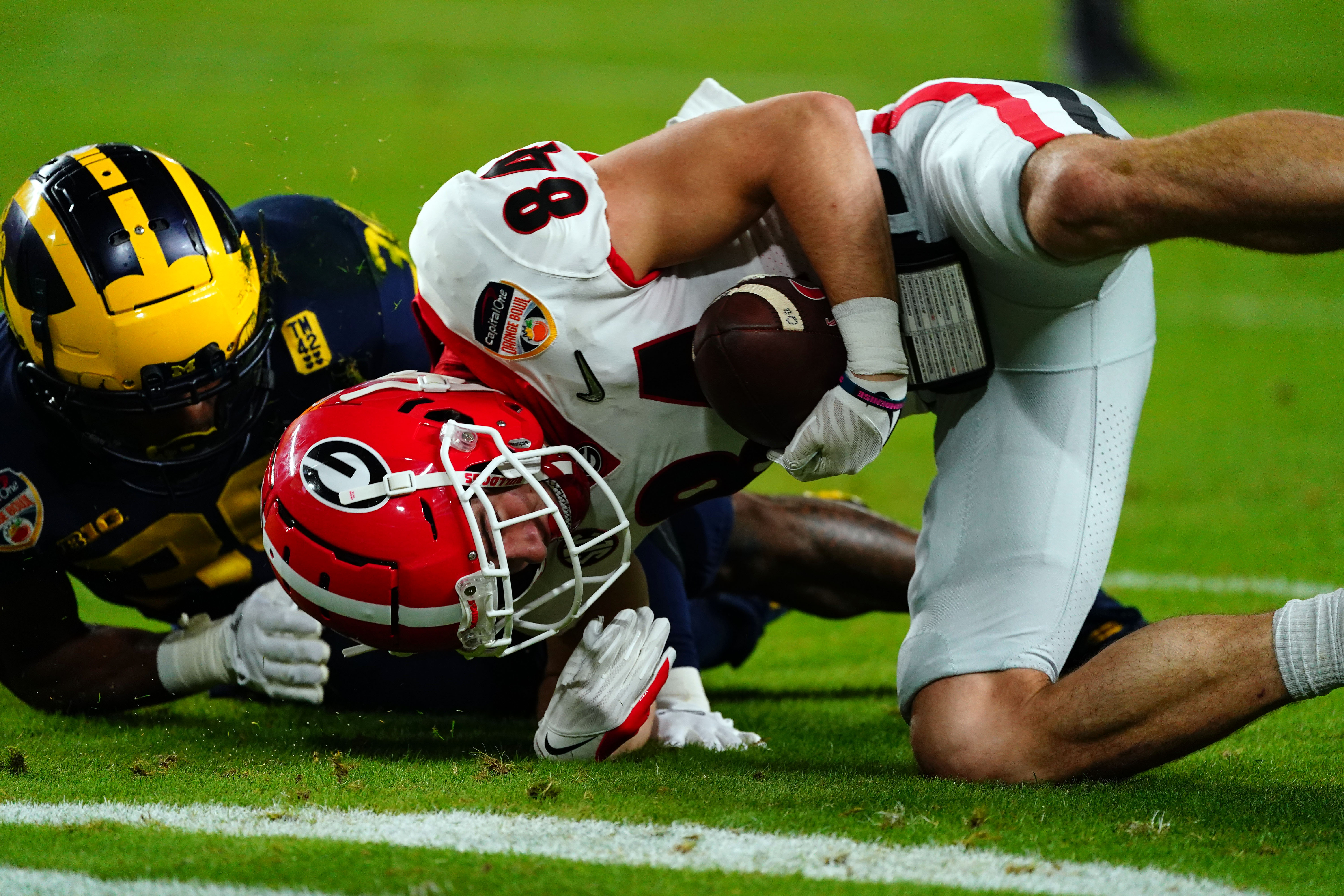 Football players collide during tackle