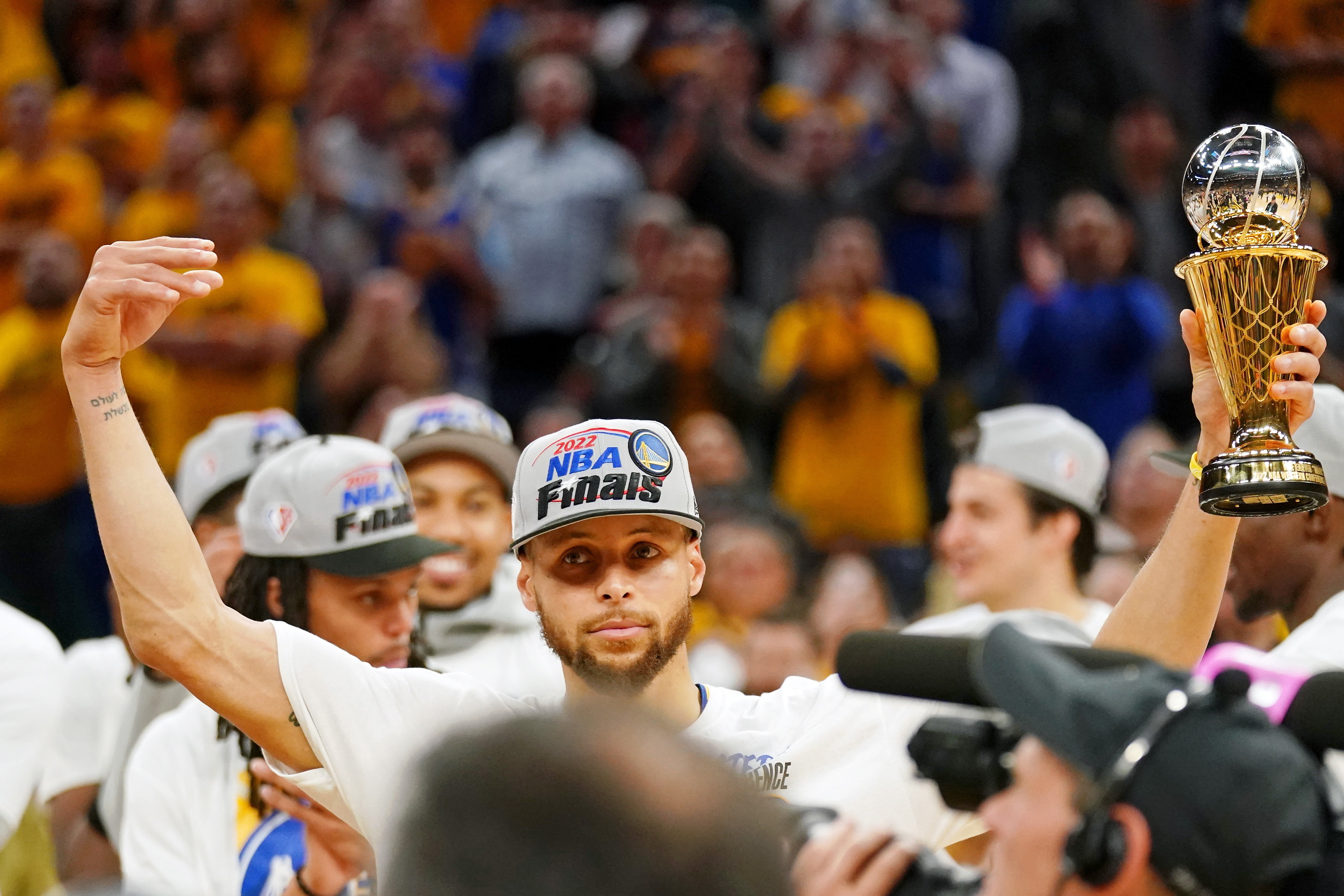 Steph Curry celebrates with Finals trophy