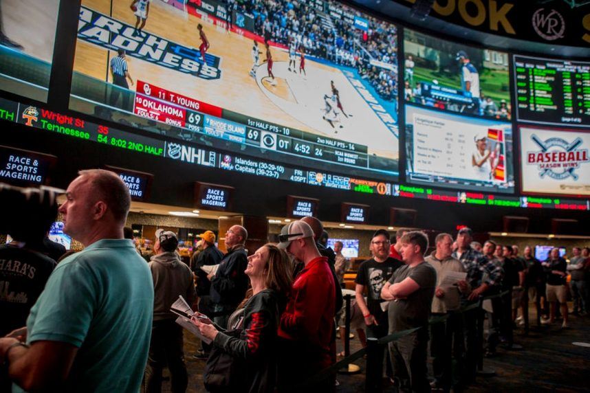 Fans watching basketball at betting venue