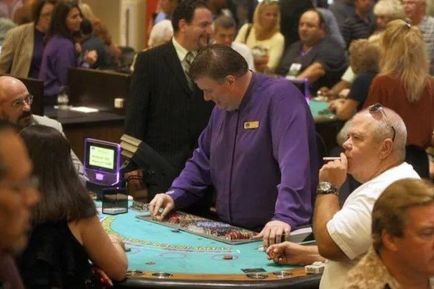 Dealer standing at casino table