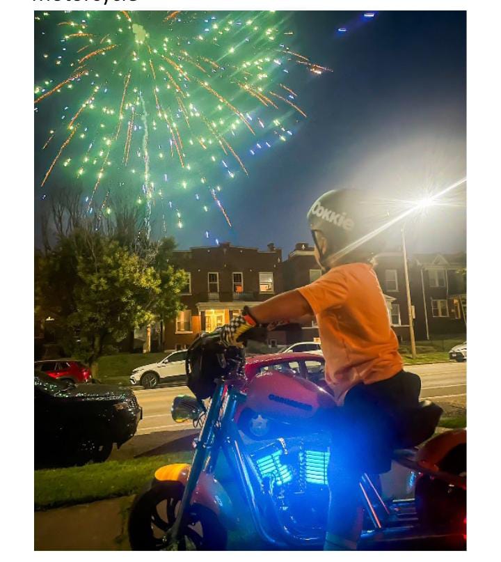 Motorcycle next to illuminated house