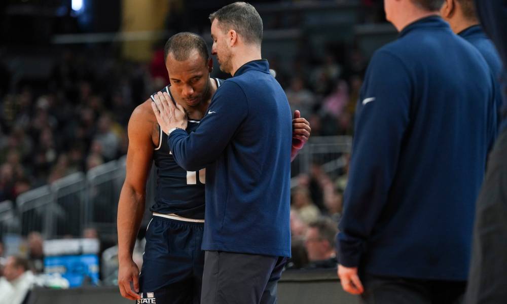 Two men conversing on basketball court