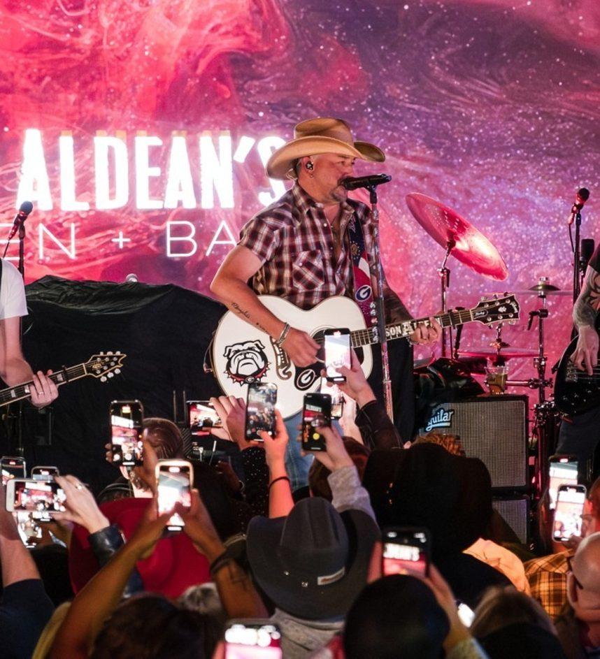 Jason Aldean singing on concert stage