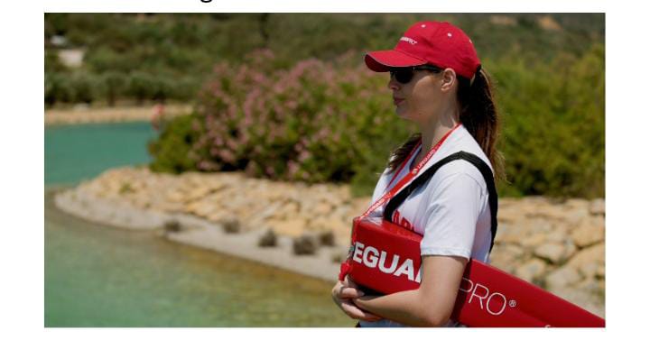 Woman holding float with red hat