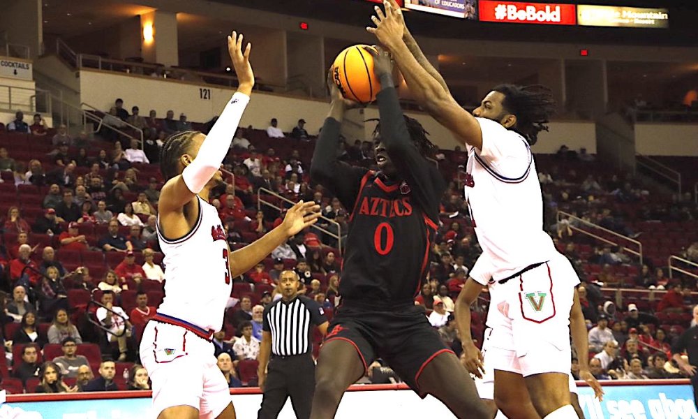 Basketball player soaring with ball