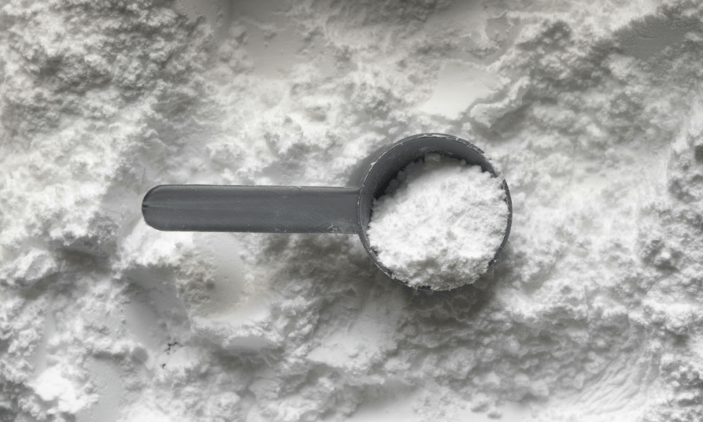 White powder scoop on flat surface