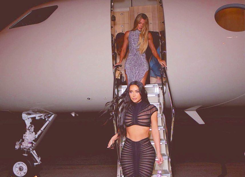 Kim and Khloe Kardashian exiting plane