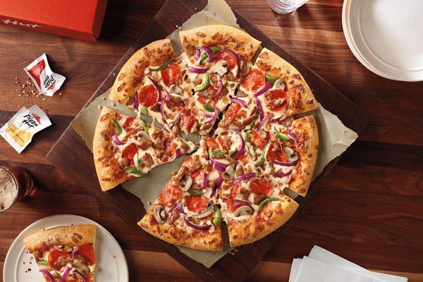 Pizza Hut pie on wooden table