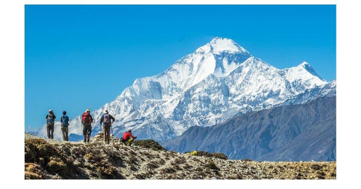 Hikers climbing while photographer captures scene