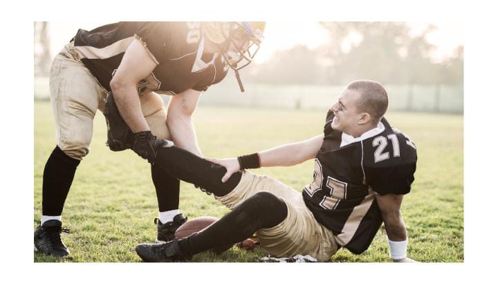 Injured player down on football field