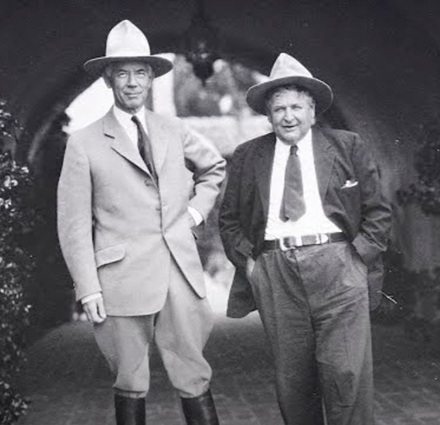 Two suited men in fedora hats