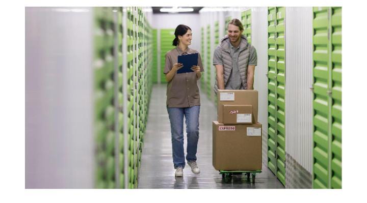 Workers moving boxes in warehouse