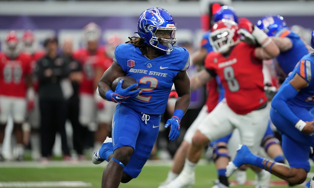 Football player carrying ball in blue