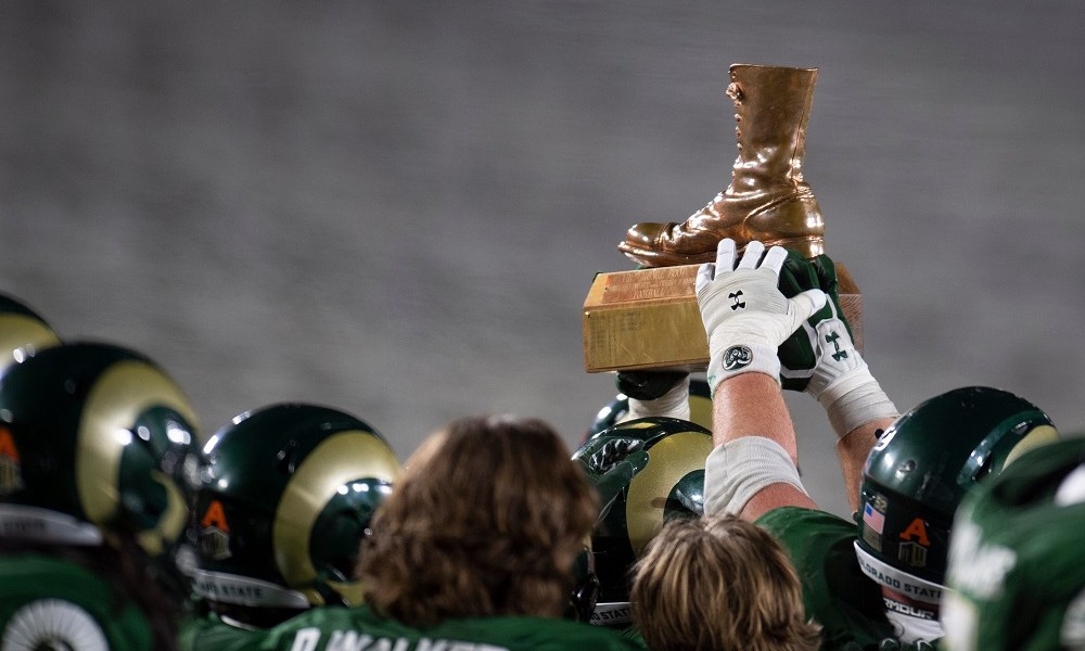 Football team celebrates with championship trophy