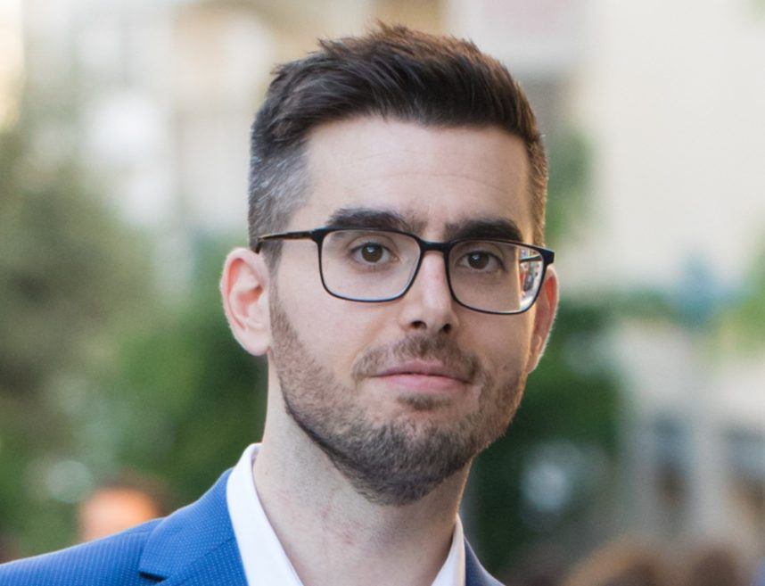 Man wearing glasses and blue suit