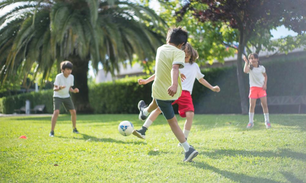 Kids playing soccer outdoors