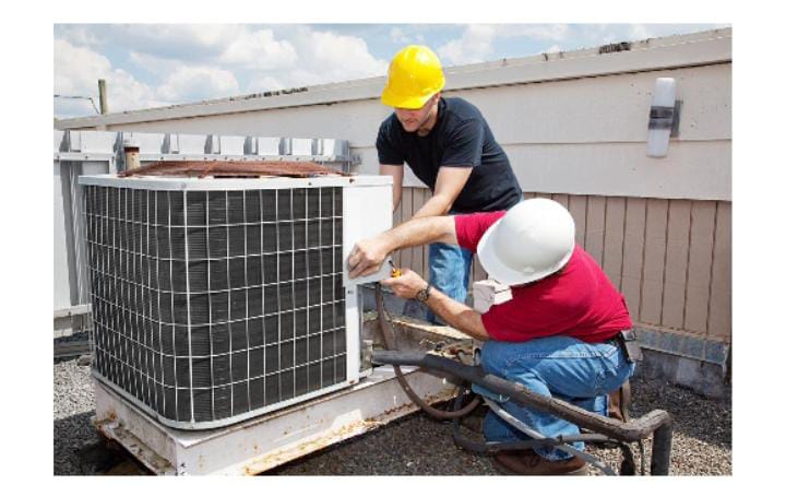 Two technicians repairing air conditioner