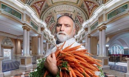 Man holding carrots at bazaar