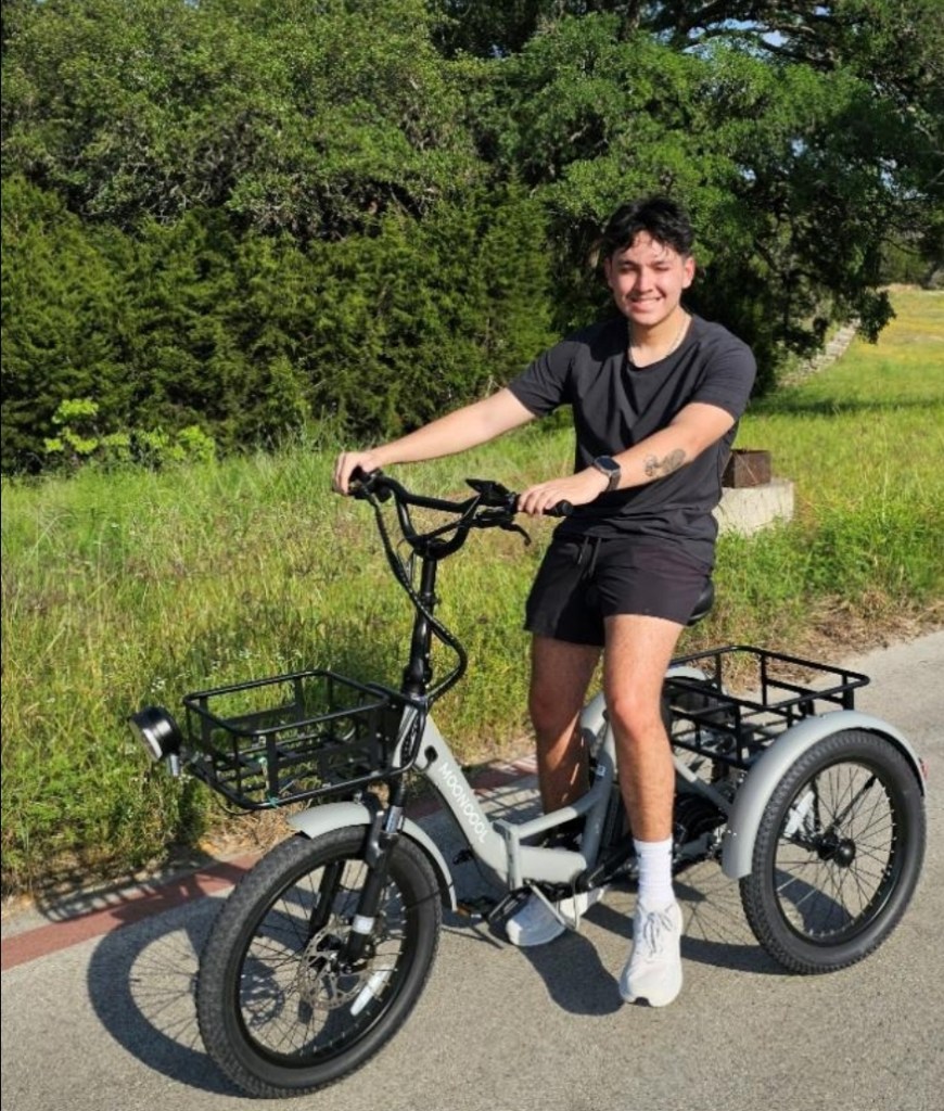 Man on tricycle outside